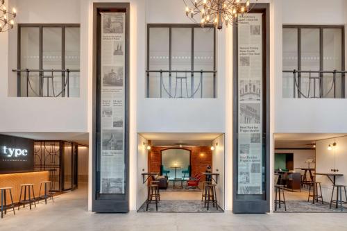 a view of the lobby of a building with tables at Hermitage Hotel Prague in Prague