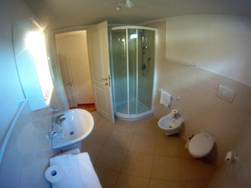 a bathroom with a sink and a shower and a toilet at charmante apartament lake front in Malcesine
