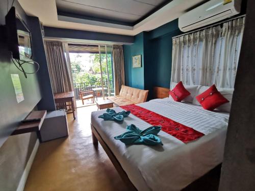 a bedroom with a bed with red and blue walls at L'NER chiang mai in Chiang Mai