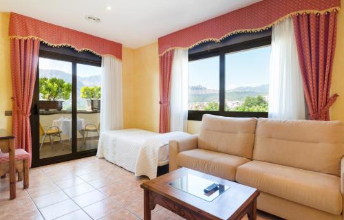 a living room with a couch and a table at Hotel Restaurant Cal Petit in Oliana