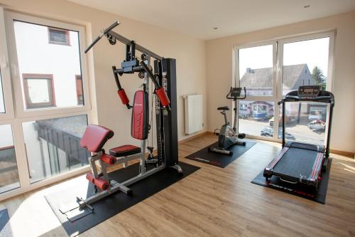 a gym with two treadmills and a treadmill at Haus Hubertus in Winterspelt