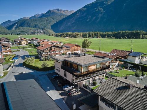 an aerial view of a town with mountains in the background at MYALPS Jordans Lodge in Längenfeld