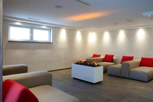 a waiting room with two couches and a fireplace at Haus Hubertus in Winterspelt