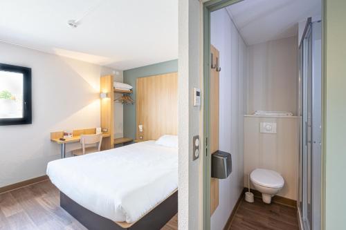 a hotel room with a bed and a toilet at B&B HOTEL Angers Parc Expos in Saint-Sylvain-dʼAnjou