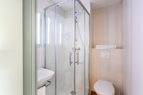 a bathroom with a shower stall and a toilet at B&B Hôtel Angers Parc Expos in Saint-Sylvain-dʼAnjou