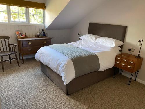 a bedroom with a bed and a table and a chair at Black Lion Inn in Leek