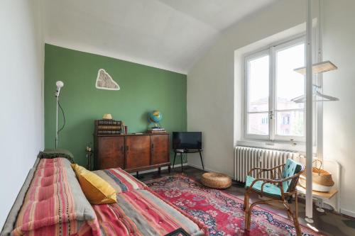 a bedroom with a bed and a chair and a window at Milano Style Apartment in Città Studi in Milan