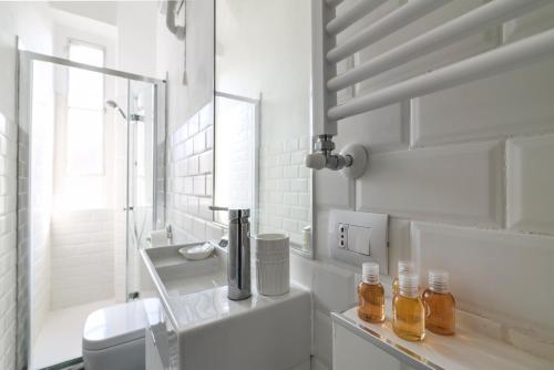 a bathroom with a sink and a toilet and a mirror at Milano Style Apartment in Città Studi in Milan