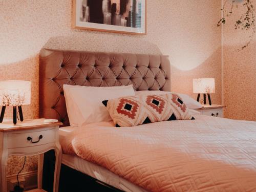 a bedroom with a large bed with two night stands at Genesta House in Cowes