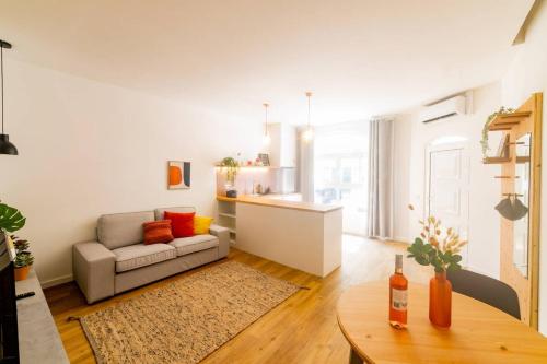 a living room with a couch and a table at Faro Central - Holiday Apartments in Faro