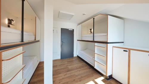 two views of a room with white closets at The Bunk Hostel in Essen