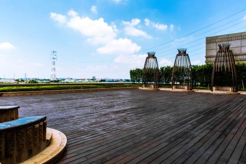a row of benches on a boardwalk at Junluxe Hotel Guangzhou Zengcheng-Free Shuttle Bus For Canton Fair in Zengcheng