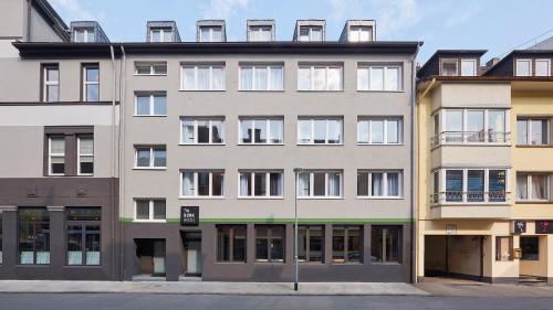 a large apartment building with windows on a street at The Bunk Hostel in Essen