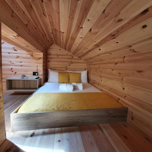 a bedroom with a bed in a wooden room at Dream House Hotel & Spa in Kolašin
