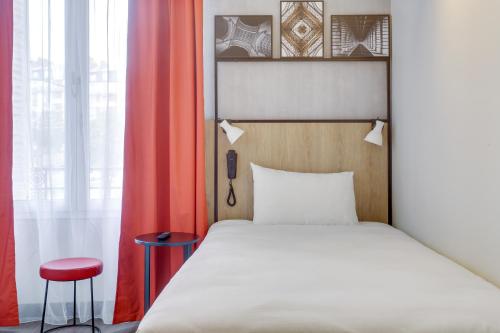 Ein Bett oder Betten in einem Zimmer der Unterkunft ibis Daumesnil Porte Doree