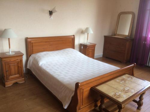 a bedroom with a bed and two night stands and a mirror at Grand gîte de Soumeillan in Castelnau-Magnoac