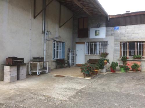 a large building with a courtyard with potted plants at Grand gîte de Soumeillan in Castelnau-Magnoac