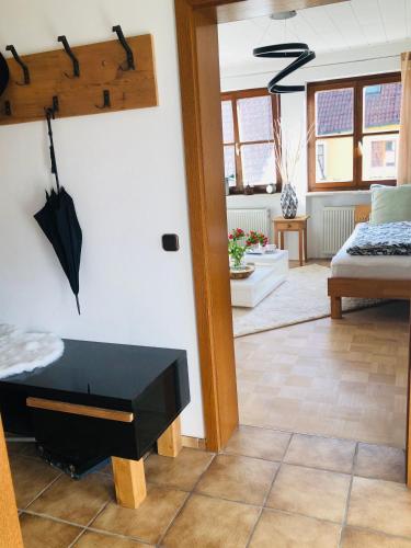 a room with a bed and an umbrella on the wall at Idyllische Ferienwohnungen in Mossendorf in Burglengenfeld