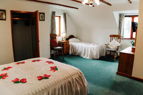 a hotel room with two beds and a bedroom at The Farmhouse Lochmeyler in Llandeloy