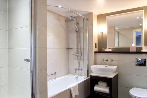 a bathroom with a sink, toilet and shower at London Chigwell Prince Regent Hotel, BW Signature Collection in London