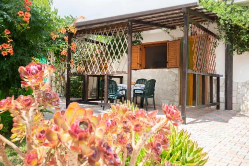 a patio of a house with a table and chairs at Agriturismo Posta Pastorella in Vieste