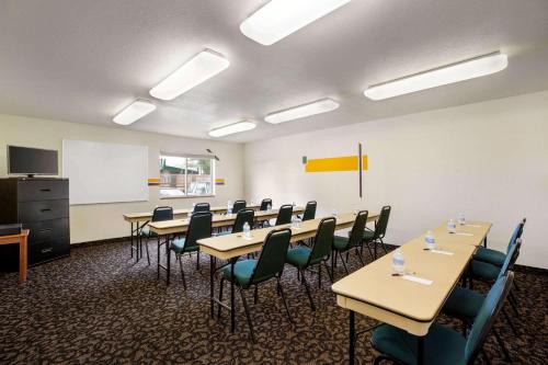 a conference room with tables and chairs and a whiteboard at Travelodge by Wyndham North Platte in North Platte