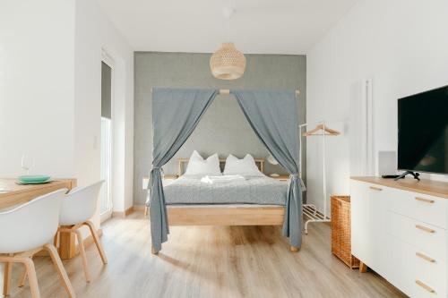 a bedroom with a bed with a canopy at ShortStayPoland Marymoncka in Warsaw