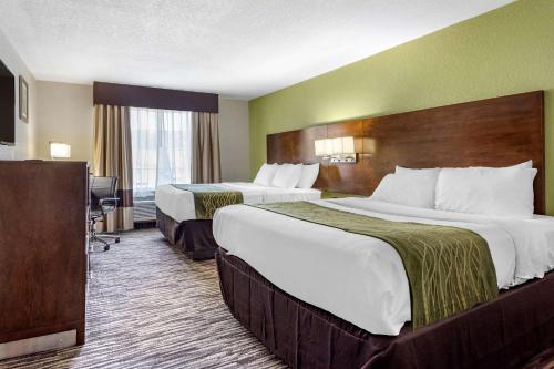 a hotel room with two beds and a television at Comfort Inn & Suites North Little Rock JFK Blvd in North Little Rock