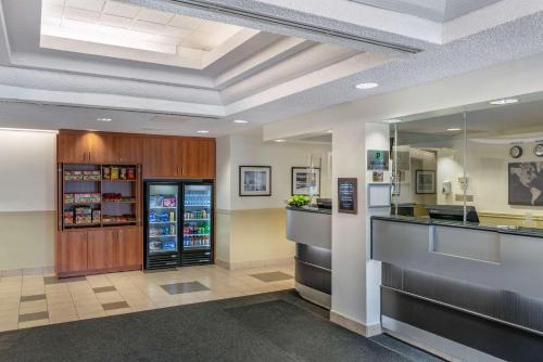 a restaurant lobby with a counter and a refrigerator at Quality Inn and Suites Montreal East in Montréal