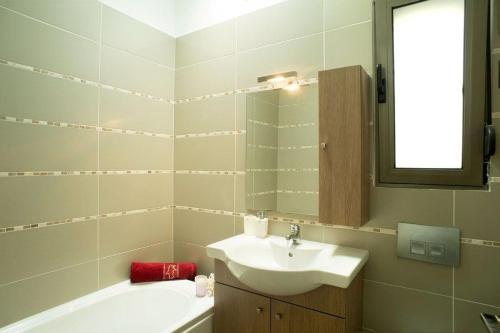 a bathroom with a sink and a mirror and a tub at Executive Rhodes Villa Villa Ellie Enas 2 Bedroom Villa with Sea Views Pefkos in Pefki