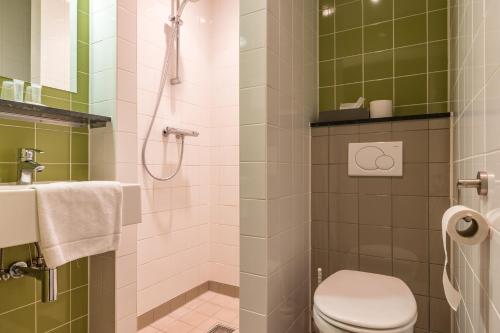 a bathroom with a toilet and a shower at Hotel Oostergoo in Grou