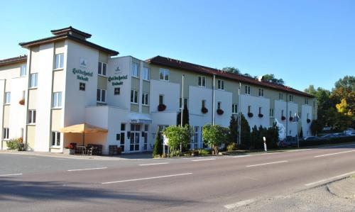a large white building on the side of a road at Heidehotel Lubast in Lubast