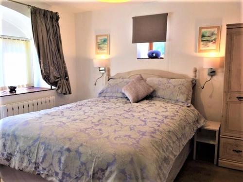 a bedroom with a large bed and a window at The Coach House in Ruthin
