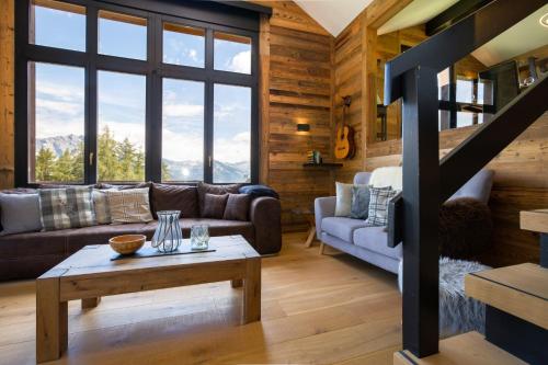a living room with a couch and a table at Paradise Awaits in the Mountains of La Tzoumaz in La Tzoumaz