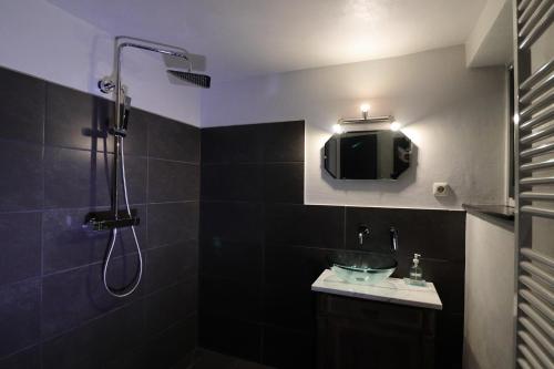 a bathroom with a shower and a sink and a tv at Art of Living in Plön