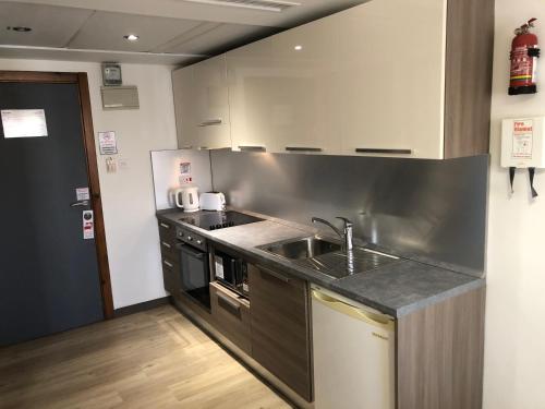 a kitchen with a sink and a counter top at Sunseeker Holiday Complex in St Paul's Bay