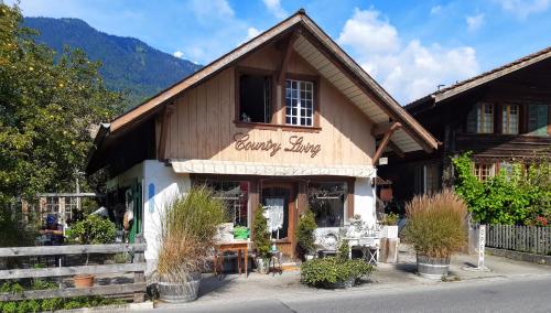 a building with a sign that reads country shop at Jobling's Holiday Apartment in Interlaken