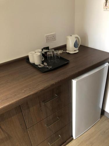 a kitchen with a wooden counter top with a appliance at Sunseeker Holiday Complex in St Paul's Bay