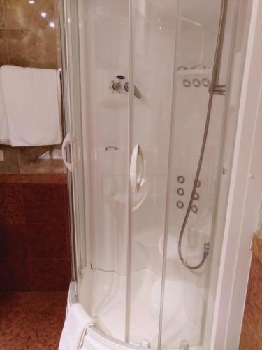 a shower with a glass door in a bathroom at Hotel Columbus in Lignano Sabbiadoro