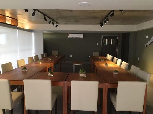 a conference room with a long wooden table and chairs at Hotel do Mar Cabo Branco in João Pessoa