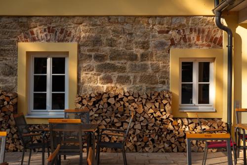 two windows and a wall of fire wood at Skalní Mlýn Adršpach in Adršpach