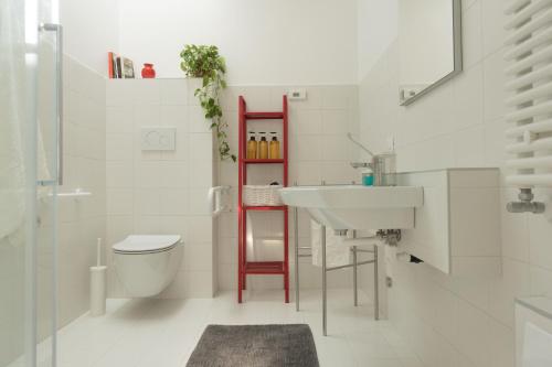 a white bathroom with a sink and a toilet at Da Coco - Apartments in Padova