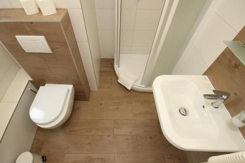 a bathroom with a sink and a toilet and a shower at City Centre in Prague