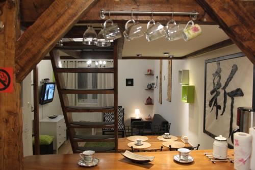 a room with a wooden table and a spiral staircase at PrivOffice4U Samurai - Old Town, Main Square, Main station in Krakow