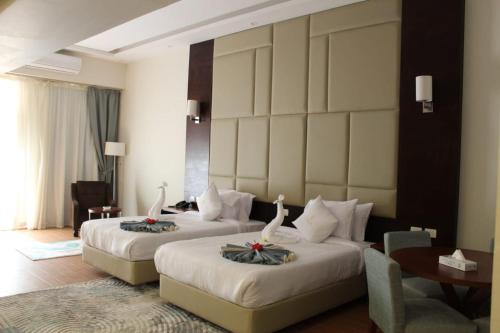 a hotel room with two beds in a room at Royal Jewel Al Raml Hotel in Alexandria