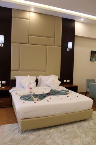 a bedroom with a large bed with flowers on it at Royal Jewel Al Raml Hotel in Alexandria