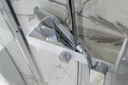 a shower with a faucet in a bathroom at CG Kensington in London
