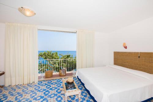 a bedroom with a bed and a view of the ocean at Casa Fioravante in Positano