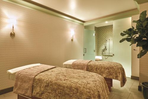 a hotel room with two beds and a shower at Park MGM Las Vegas in Las Vegas