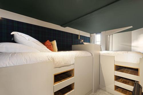 two bunk beds in a room with at Hotel Le Chabichou in Courchevel